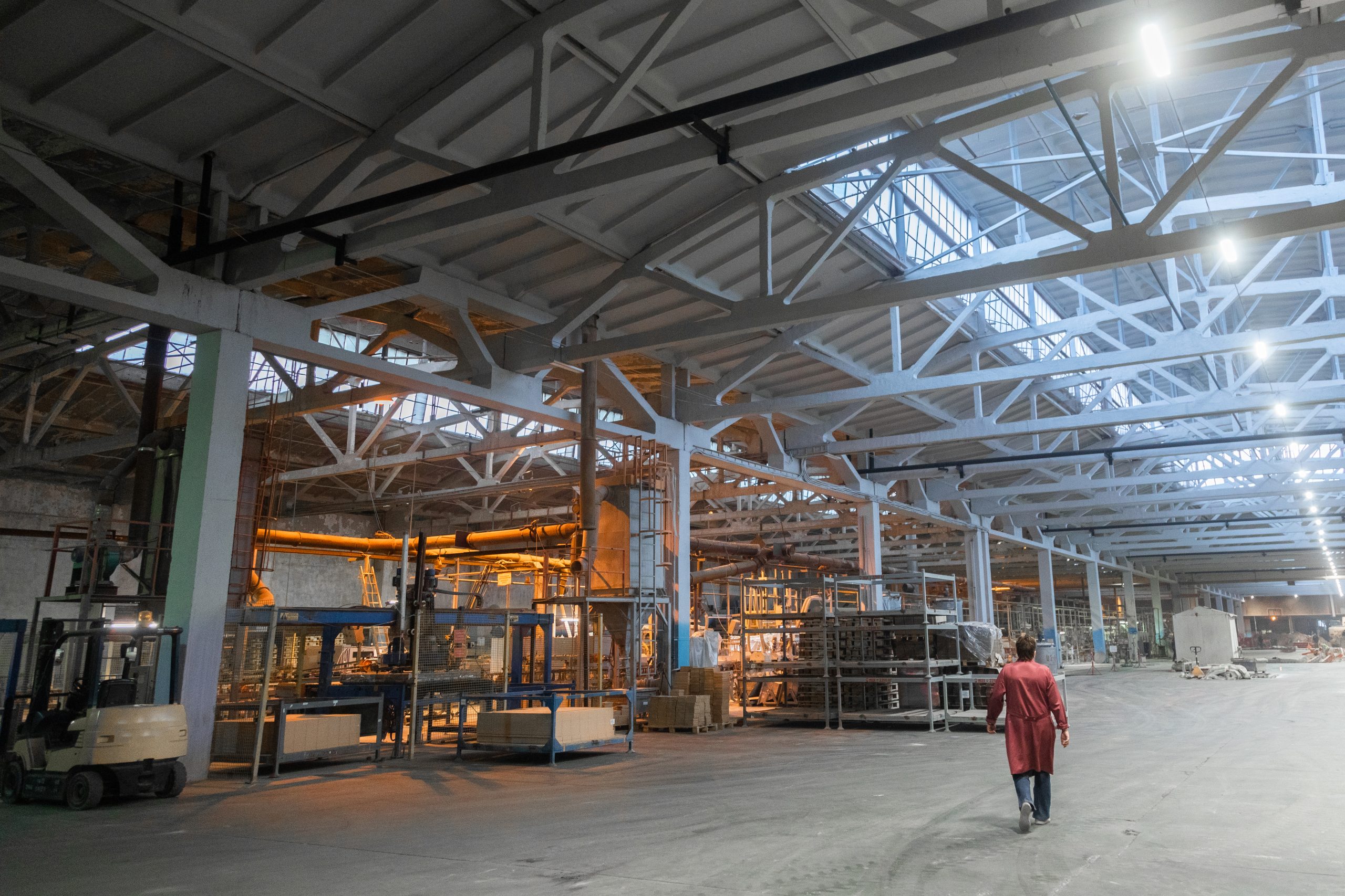 Cement factory interiors. Industrial cement production conveyor. Workers in the shop on the production line